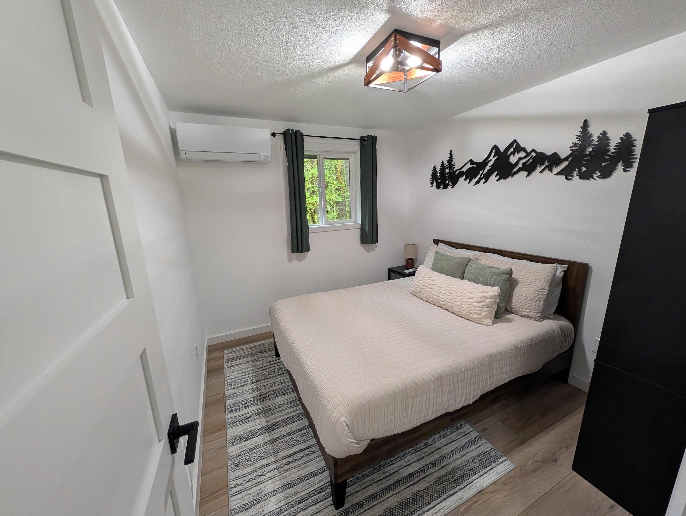 Very nice modern bedroom with a heat pump unit on the wall