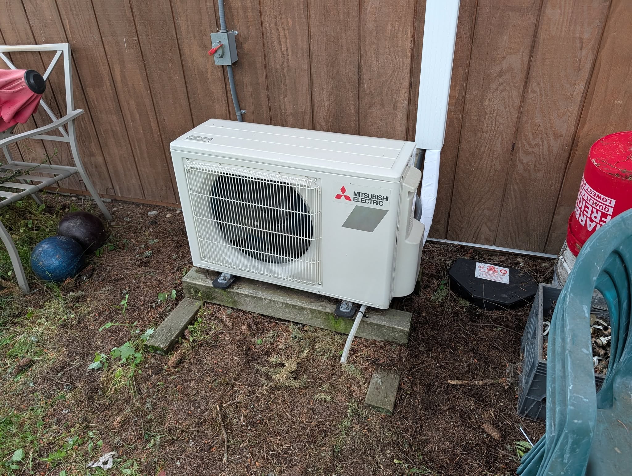 New Mitsubishi Heat Pump installed on the outside of a house